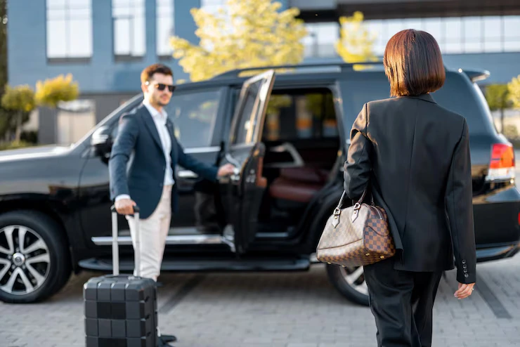 Passengers with luggage boarding Stansted Airport taxi
